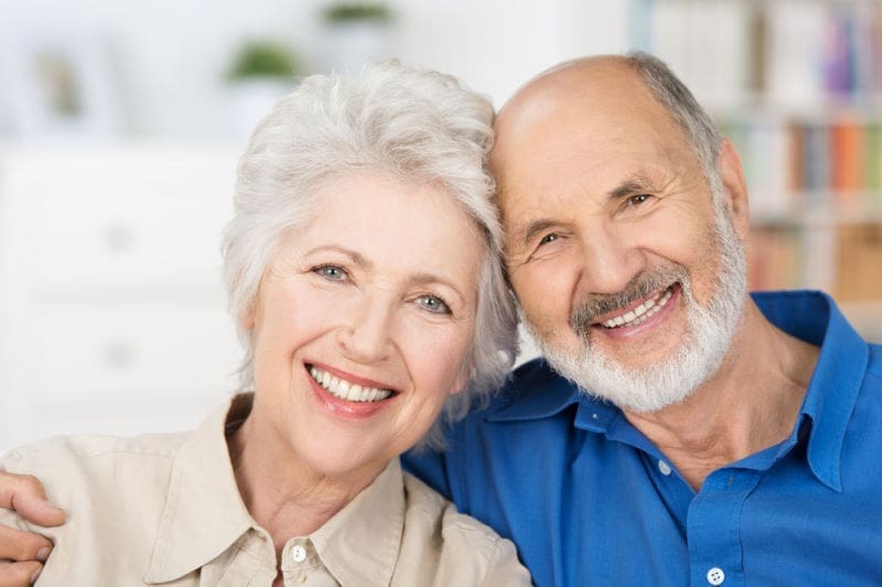 Older couple smiling | Dental bridges | Dental implants melrose